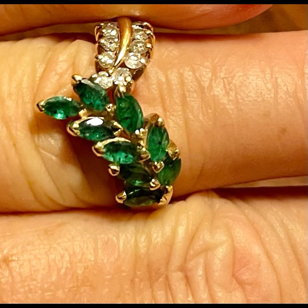 Genuine emerald and diamond ring set in solid 14carat gold. Size 6.